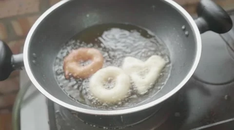 Dougnuts fried in slow motion Stock Footage 60689045