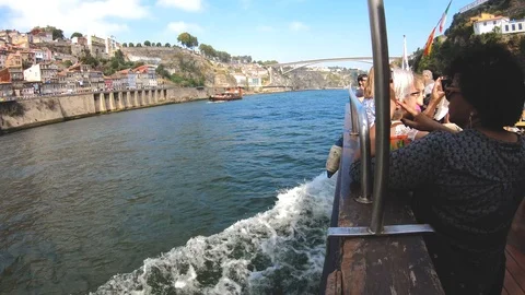 DOURO RIVER AND A BOAT WHILE A WOMAN TAKES A PHOTO Stock Footage 95095326