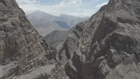 Down to Up Drone Between Two Ladakh Mountain Peaks Revealing Snow Covered Stock Footage 335764807