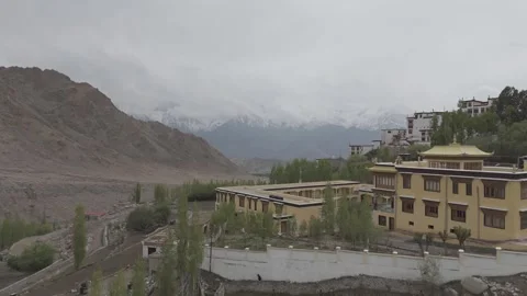 Down to Up Drone Reveal of Ladakh Monastery with Snow Peaks and Valleys in the Vídeos de archivo 335759889