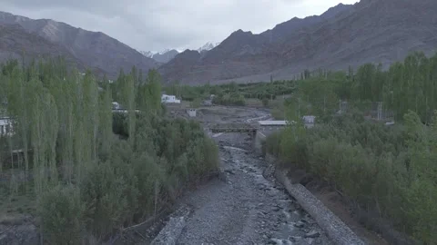 Down to Up Drone Reveal of Ladakh River Stream Surrounded by Forest Peaks in Stock Footage 335760084