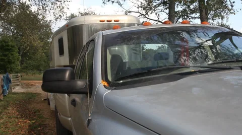 Down moving Jib shot at a farm with a dog and horse trailer Video stock 31743090