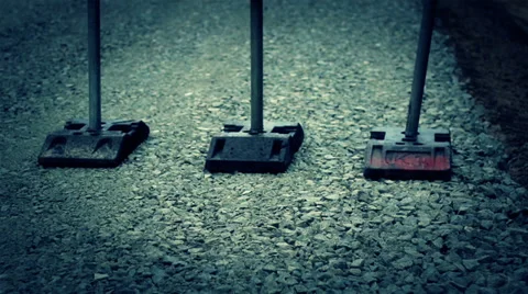 Down right road sign standing on gravel ground Stock Footage