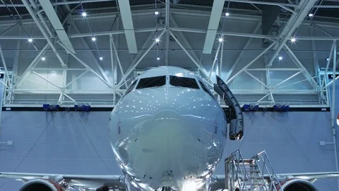 Up-Down Shot of a Brand New Airplane Standing in a Aircraft Maintenance Hangar.  Stock Footage