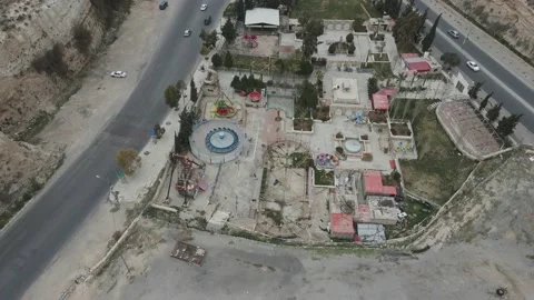Down slide drone flight viewing the abandonned theme park of karak Stock Footage 183981446