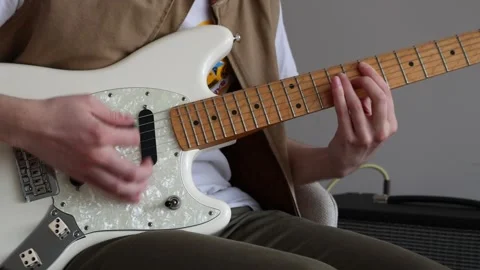 Down strumming on an electric guitar Stock Footage 333389494