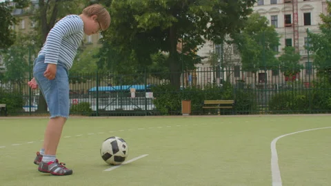 Down syndrome boy plays ball soccer field friends. He makes pass, played ball. Stock Footage 157784539