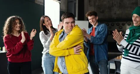 Down syndrome man with friends in community center, inclusivity and unity Stock Photos