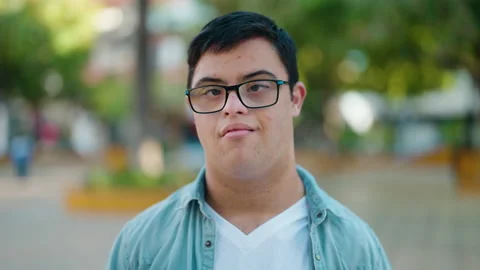 Down syndrome man smiling confident standing at park Stock Footage 170634816