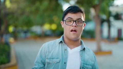 Down syndrome man smiling confident speaking at park Video stock 170634832