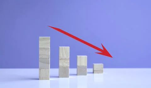 Down trend with red arrow down from stacked wooden cubes. 写真素材