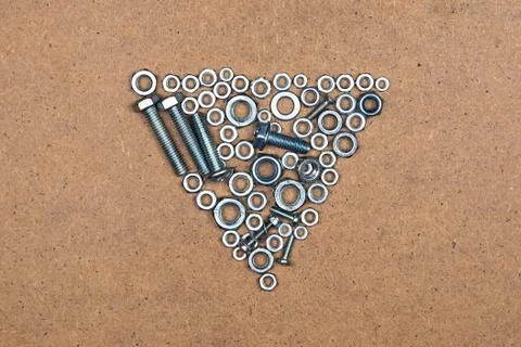 Down triangle from bolts and nuts Stock Photos