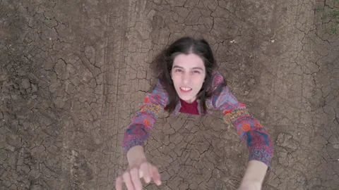 Down Vertical Push In to Brunette Young Lady Trying to Reach the Drone Vidéo 289670149