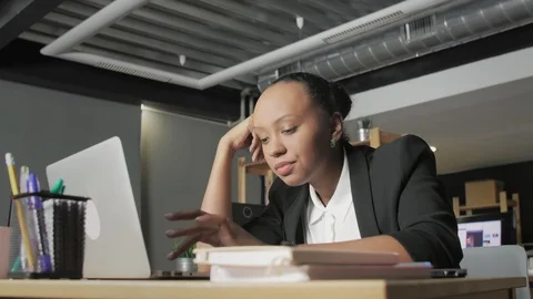 Down view of boring african american woman wants to sleep and tries to work Video stock 128436586