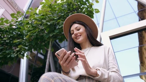 Down view of charming happy cheerful woman in modish hat which sitting near big Stock Footage 120184021