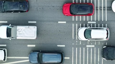 A down view reveals severe traffic jams on a paved city road. Video stock 320594187
