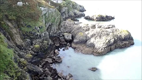 Down View to the Sea of Rocky Mountain Cliff  from Ben of Howth, Ireland Stock Footage 77839147