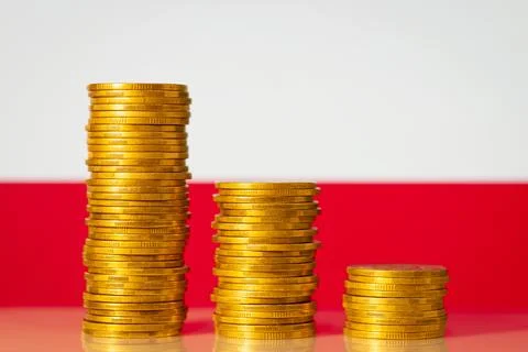 Downcomming graph made of gold coins against flag of Poland Stock Photos
