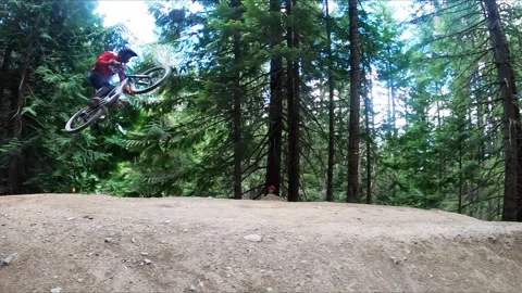 Downhill Mountain Biker Going Ove A Jump Stock Footage 282307204