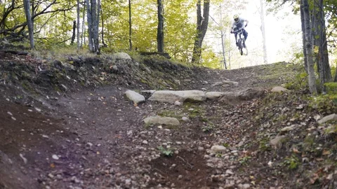 Downhill Mountain biker rides through berm Stock Footage 88687512