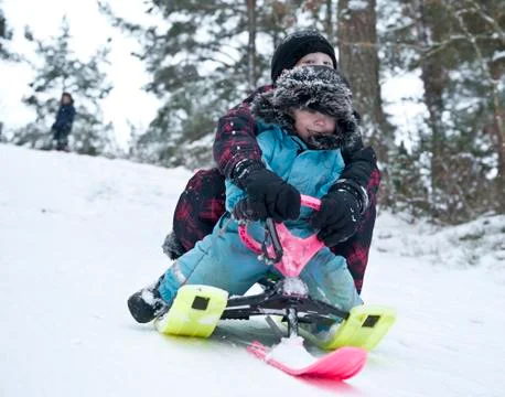 Downhill on a snow sledge Stock Photos