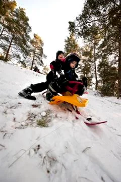 Downhill on a snow sledge Stock Photos