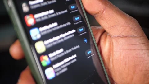Downloading an app on a smartphone (at an angle) Stockbeeldmateriaal 307596096