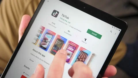 Downloading TikTok App on a Tablet Screen Stock Footage 146997889