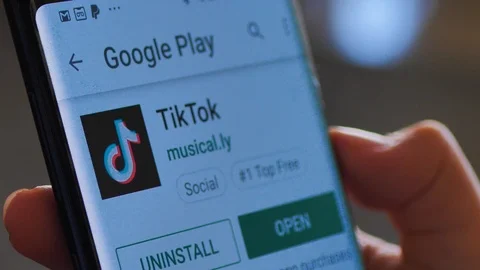 Downloading TikTok music.ly on google app store Stock Footage