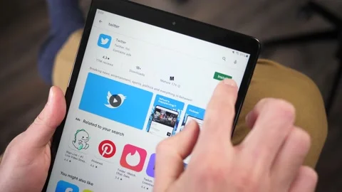 Downloading the Twitter App On a Tablet Screen Stock-Footage 146994941