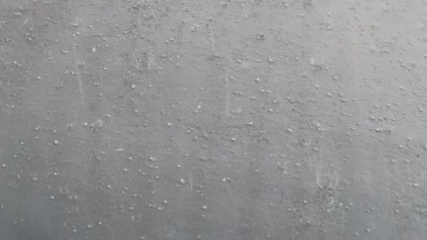Downpour of large heavy rain droplets and hail splashing on a grey flat roof Stock Footage 173479175