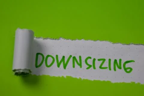 Downsizing Text written in torn paper 库存照片