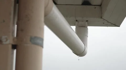 Downspout dripping water while it's raining Stock Footage 207600852