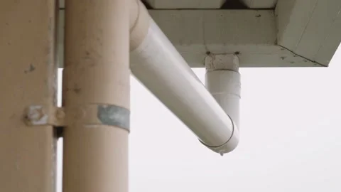 Downspout or "downpipe" dripping water while it's raining Stock Footage 207600811