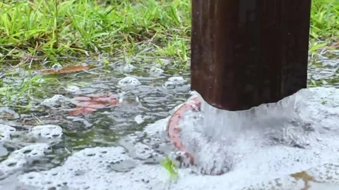 A downspout overflowing during an afternoon rain shower. Stock Footage 280010032