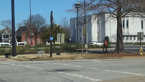 Downtown Augusta Georgia man on a hover board traveling down the sidewalk Stock Footage 149049898