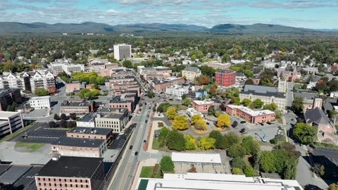 Downtown Glens Falls roundabout and churches aerial, New York Stock Footage 347004135