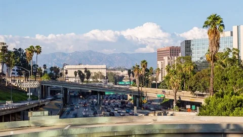 Downtown Los Angeles Freeway with Palm Trees, Mountains and Clouds Timelapse Stock Footage