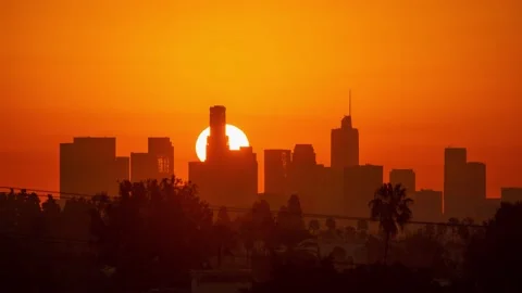 Downtown Los Angeles. Sunrise sun over city buildings silhouettes, zoom out 4K Stock Footage 143128809