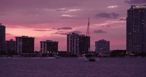 Downtown Miami from  Key Biscayne sailboat close-up purple haze sunset Stock Footage 241611237