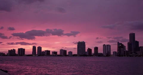 Downtown Miami from  Key Biscayne  slow pan medium purple haze sunset Stock Footage 241603246