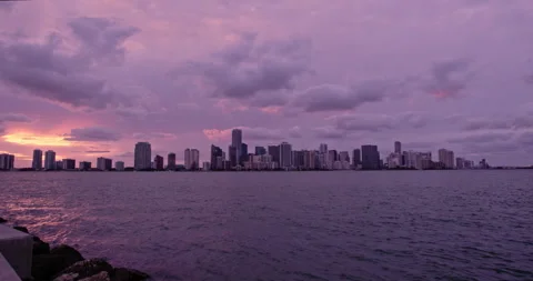Downtown Miami from  Key Biscayne  sunset extreme wide slow pan purple haze Stock Footage 241610425