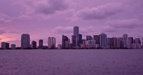 Downtown Miami from  Key Biscayne  sunset slow pan purple haze 4 Stock Footage 241610612