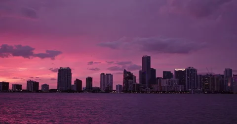 Downtown Miami from  Key Biscayne wide purple haze saturated sunset Stock Footage 241611313