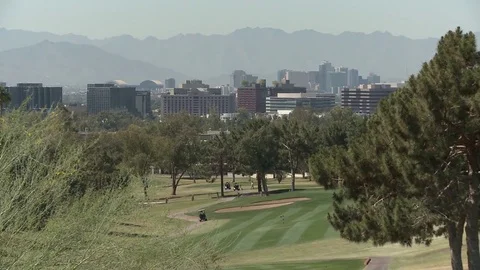Downtown Phoenix skyline with golfer foreground HD Stock Footage 75500851
