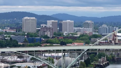 Downtown skyscrapers rise above multi-level highway overpass and lush greenery Stock Footage 337745846