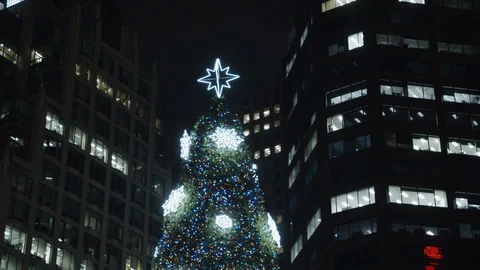 Downtown square christmas tree set against office buildings in background Stock Footage 121565622