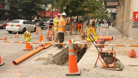 Downtown Vancouver Construction Crew Working on Laying Pipe in Concrete Trench Stock Footage 94048668