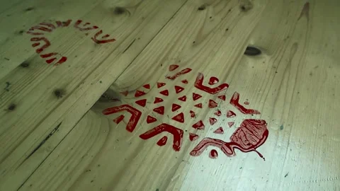 Downward angle orbiting of bloody boot mark on wood flooring. Crime scene Stock Footage 319468036