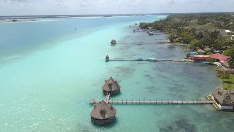 Downward Drone of Light Blue and Clear Water in Bacalar, Mexico with Palm Huts Stock Footage 89812053